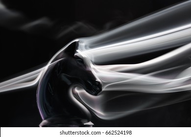A beautiful chess piece of a horse wrapped in smoke