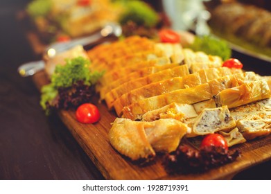 Beautiful Chicken And Mushroom Pie With Herbs, Tomatoes And Chicken Legs On A Wooden Board In A Restaurant. Selective Focus, Close-up.