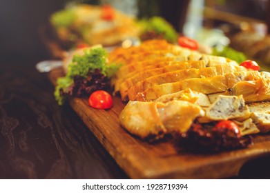 Beautiful Chicken And Mushroom Pie With Herbs, Tomatoes And Chicken Legs On A Wooden Board In A Restaurant. Selective Focus, Close-up.