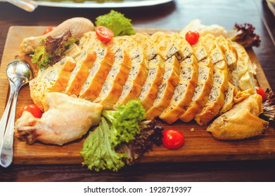 Beautiful Chicken And Mushroom Pie With Herbs, Tomatoes And Chicken Legs On A Wooden Board In A Restaurant. Selective Focus, Close-up.