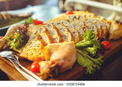 Beautiful Chicken And Mushroom Pie With Herbs, Tomatoes And Chicken Legs On A Wooden Board In A Restaurant. Selective Focus, Close-up.