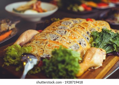 Beautiful Chicken And Mushroom Pie With Herbs, Tomatoes And Chicken Legs On A Wooden Board In A Restaurant. Selective Focus, Close-up.