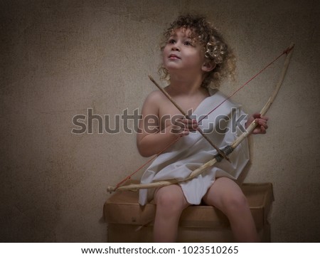 A beautiful child with blonde curly hair and a bow and arrow as cupid, appearing as an oil painting as a Valentine's Day. The God of Love, represented in a photo appearing as an oil painting. 