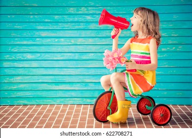 Beautiful Child With Bouquet Of Flowers Against Wooden Background. Spring Family Holiday Concept. Mother's Day