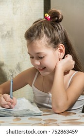 Beautiful child is doing the schoolwork.
