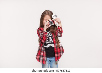 Beautiful child girl holding a instant camera - Powered by Shutterstock