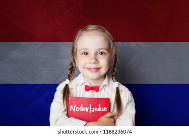 Beautiful child girl smiling and holding book in Netherlandish language school. Learning Dutch