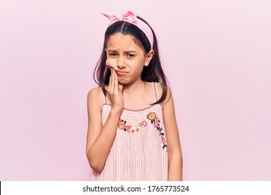 Beautiful Child Girl Wearing Casual Clothes Touching Mouth With Hand With Painful Expression Because Of Toothache Or Dental Illness On Teeth. Dentist 