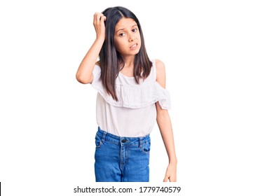 Beautiful Child Girl Wearing Casual Clothes Confuse And Wonder About Question. Uncertain With Doubt, Thinking With Hand On Head. Pensive Concept. 