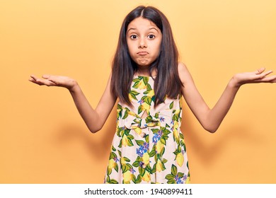 Beautiful Child Girl Wearing Casual Clothes Clueless And Confused With Open Arms, No Idea And Doubtful Face. 