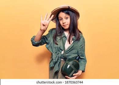 Beautiful Child Girl Wearing Explorer Hat Showing And Pointing Up With Fingers Number Four While Smiling Confident And Happy. 