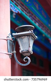 Beautiful Chinese bronze sculpture lamp at the wooden pole under the traditional eaves
