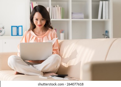 Beautiful Chinese Lady Working On Laptop At Home