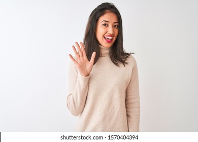 Beautiful chinese woman wearing turtleneck sweater standing over isolated white background Waiving saying hello happy and smiling, friendly welcome gesture