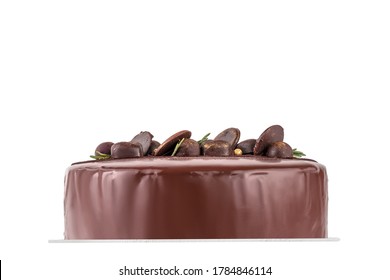 Beautiful Chocolate Cake Isolated On A White Background, Side View. Many Candies Decorating The Top Of The Dessert