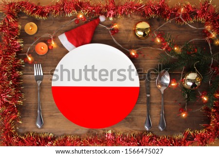 beautiful christmas composition with a plate with the national flag of poland, christmas decorations, garlands, candles, concept for traditional new year food, gastronomic tourism Stock photo © 