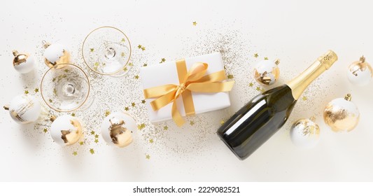 Beautiful Christmas gift, sparkling wine, white and golden decorative balls on white background. Xmas. Christmas and New Year festive greeting card. Banner. - Powered by Shutterstock