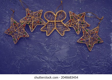 Beautiful Christmas Golden Deco Baubles On Dark Black Background. Flat Lay Design.