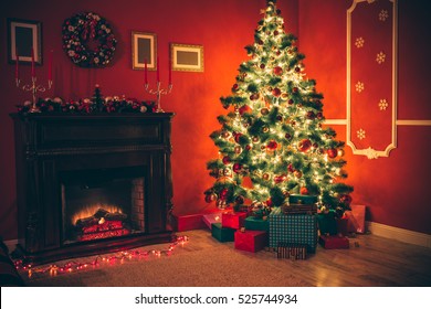 Beautiful Christmas Living Room With Decorated Christmas Tree, Gifts And Fireplace With The Glowing Lights At Night