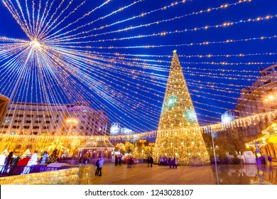 Beautiful Christmas scene with decorated tree and ornamental lights in Revolution Square of Bucharest in Romania - Powered by Shutterstock