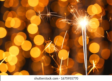 Beautiful Christmas sparklers against blurred lights - Powered by Shutterstock