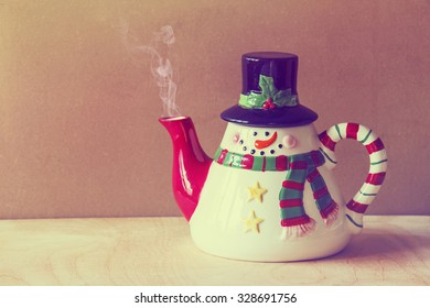 beautiful christmas style  kettle on grunge  wooden background with smoke coming out of it  