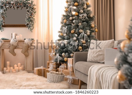 Beautiful Christmas tree in decorated living room. Festive interior