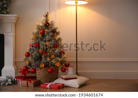 Beautiful Christmas tree and gift boxes in room. Space for text