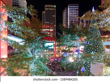 Beautiful Christmas Trees Standing In The Pedestrian Zone By A Shopping Mall In The Joyful Holiday Season And A Crowd Gathering Around A Street Busker In Xinyi Commercial District, Taipei City, Taiwan