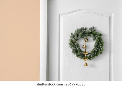 Beautiful Christmas wreath hanging on white door - Powered by Shutterstock