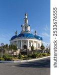 A beautiful church with blue domes and golden spires under a clear blue sky