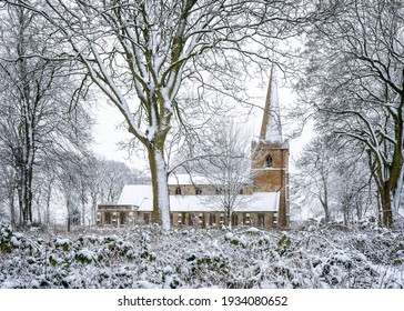 Beautiful Church In Churchyard With Snow On Roof Steeple And Trees Peaceful And Idyllic Winter Scene No People Overgrown Grave Stones