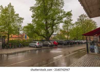 Beautiful city landscape view on cloudy rainy day. Car parking in downtown in old European city.  Sweden. Uppsala. 05.21.2022.