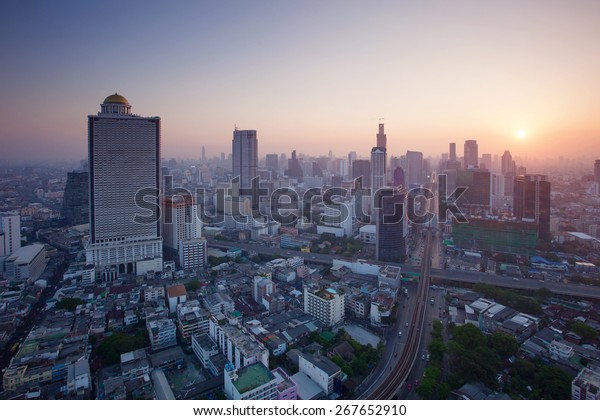 beautiful city scape urban scene  of bangkok capital of\
thailand in morning light glow up view from peak of sky scrapper\
building 