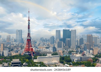 Beautiful city skyline of Downtown Tokyo, with the famous landmark Tokyo Tower standing out amid the crowded skyscrapers under rainbow sky and Zojoji Temple 增上寺 located in the nearby Shiba Koen Park