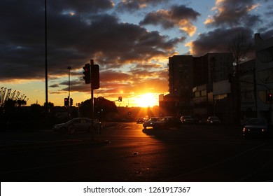 A Beautiful City Sunset With Dark Clouds Above The Road Junction With Many Cars, Signal Lights In Melbourne City ,Australia ,taken During Twilight