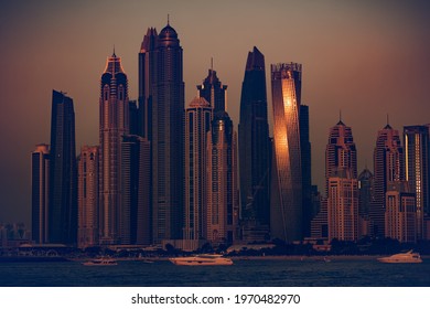Beautiful Cityscape in Evening with Mild Sunset Light. Luxury Modern Skyscrapers Stand on the Bank of the Bay where Yachts are Moored. Dubai. UAE.