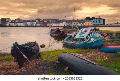 Beautiful cityscape scenery with old colorful wooden boats on the shore of Corrib River at Galway City in Ireland 
