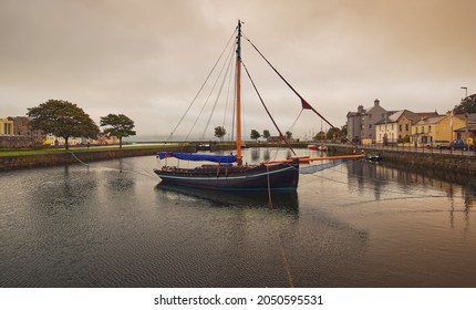 Beautiful cityscape scenery of old wooden ship in the Corrib River with colorful houses in the background at Claddagh in Galway city, Ireland 