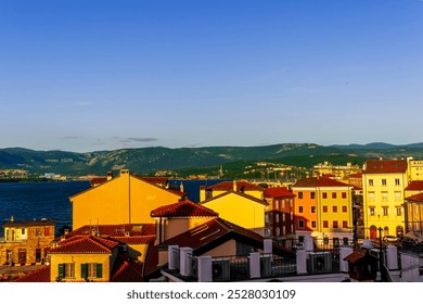 beautiful cityscape with town during sunset with blue see gulf and harbor with boats, calm water and green scenic hills with amazing cloudy sky on background - Powered by Shutterstock