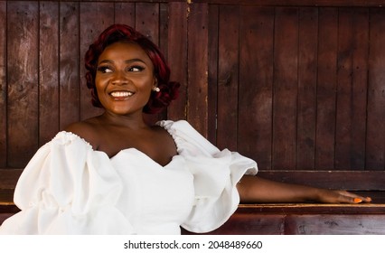 Beautiful Classy Young Black African Girl Smiling And Standing With Wooden Background And Bar 