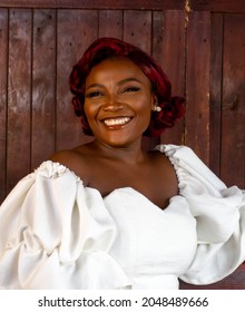 Beautiful Classy Young Black African Girl Smiling And Standing With Wooden Background And Bar 