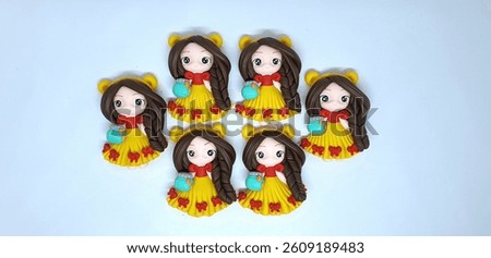 Beautiful clay doll, made of colorful clay on a white background. Cute clay chibi doll like winnie pooh cartoon character on a white background.