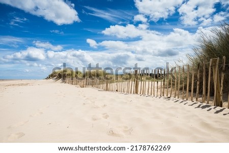 Beautiful clean sand seen next to a beach fence at Holkham on the North Norfok coast.