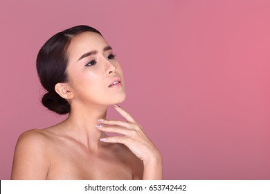 Beautiful Clean Skin Woman Straight Black Hair With Smooth Pose Open Shoulder Smile, V Shape Face, Studio Lighting Pastel Pink Background Copy Space