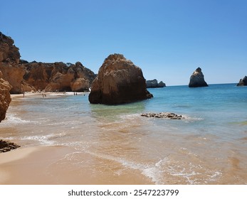 Beautiful clear sky day in a beach with Rock formation in the Sea - Powered by Shutterstock