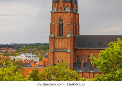 Beautiful close up of clock tower of Uppsala Cathedral pale sky background. Sweden.
