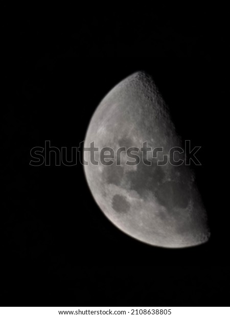 beautiful close up magnified clear bright photo of moon\
natural satellite earth showing the mountains and craters on lunar\
surface  
