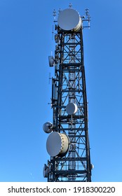 Beautiful Close Up View Of Three Rock TV Transmitter Antenna Viewed From Fairy Castle (Two Rock Mountain), Dublin Mountains, Ireland. Single Cellular Tower Top In Against Clear Blue Sky. Vertical View