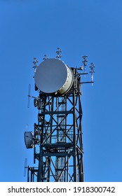 Beautiful Close Up View Of Three Rock TV Transmitter Antenna Viewed From Fairy Castle (Two Rock Mountain), Dublin Mountains, Ireland. Single Cellular Tower Top In Against Clear Blue Sky. Vertical View